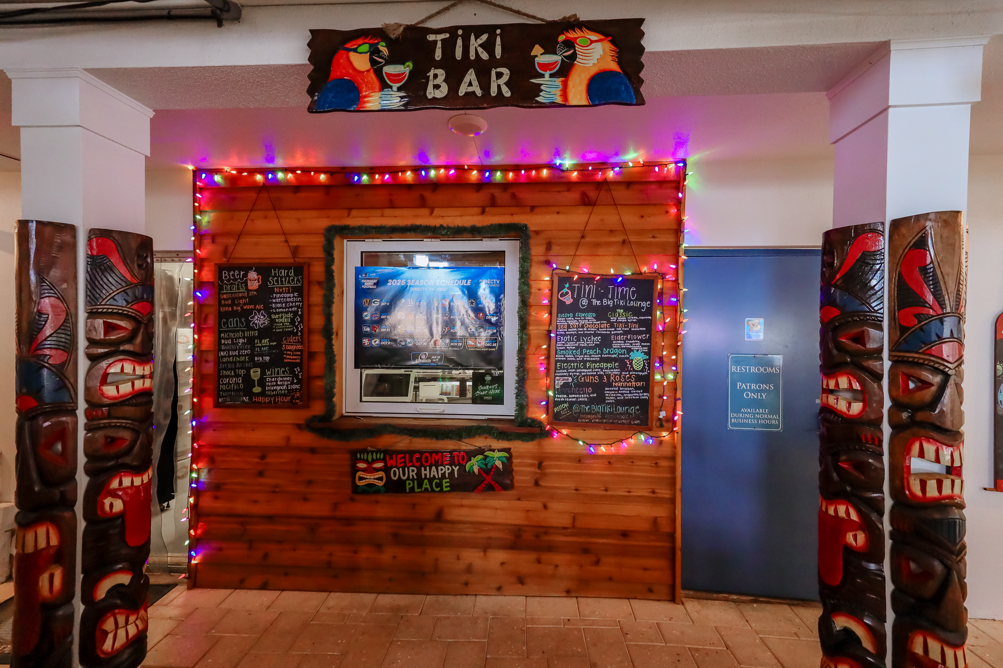 A tiki-themed bar with colorful lights and decorations